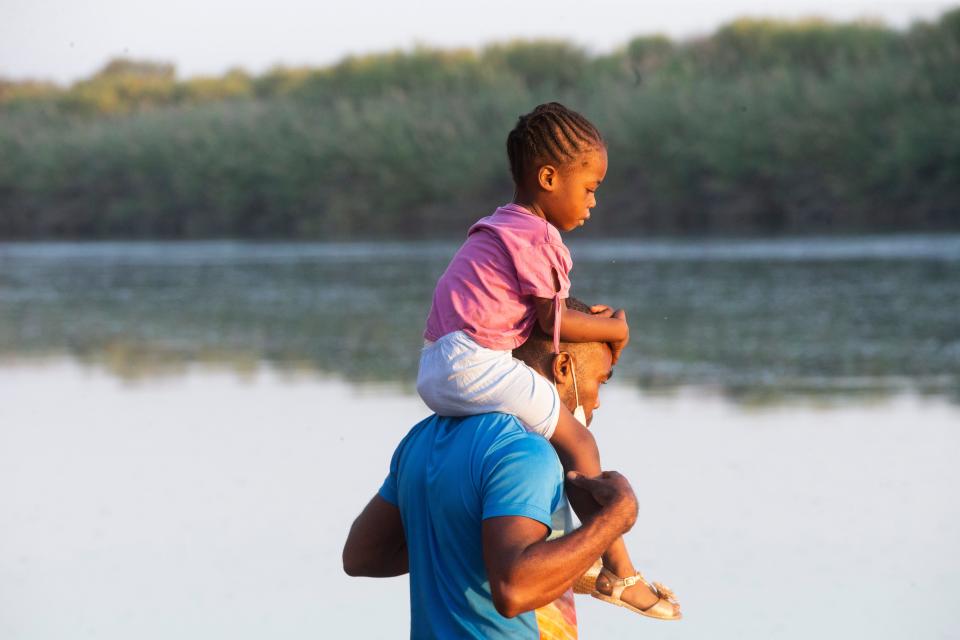 Haitian migrants cross the Rio Grande into Del Rio, Texas from Ciudad Acuna on September 18, 2021. Thousands of migrants have arrived in the border city and have camped underneath the Del Rio International Bridge on the U.S. side of the border.