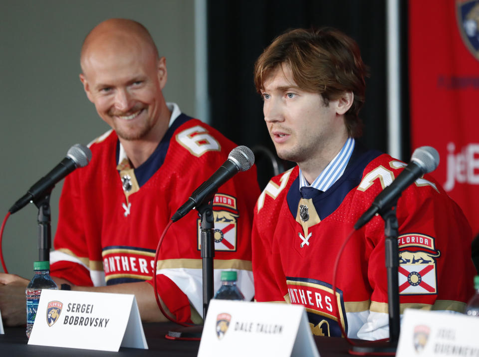 Newly acquired Florida Panthers player Anton Stralman, left, smiles as Sergei Bobrovsky speaks during an NHL hockey news conference, Tuesday, July 2, 2019, in Sunrise, Fla. The Panthers introduced Stralman, Bobrovsky, Brett Connolly and Noel Acciari. The Panthers, New York Rangers and Nashville Predators were winners on Day 1 of NHL free agency. (AP Photo/Wilfredo Lee)