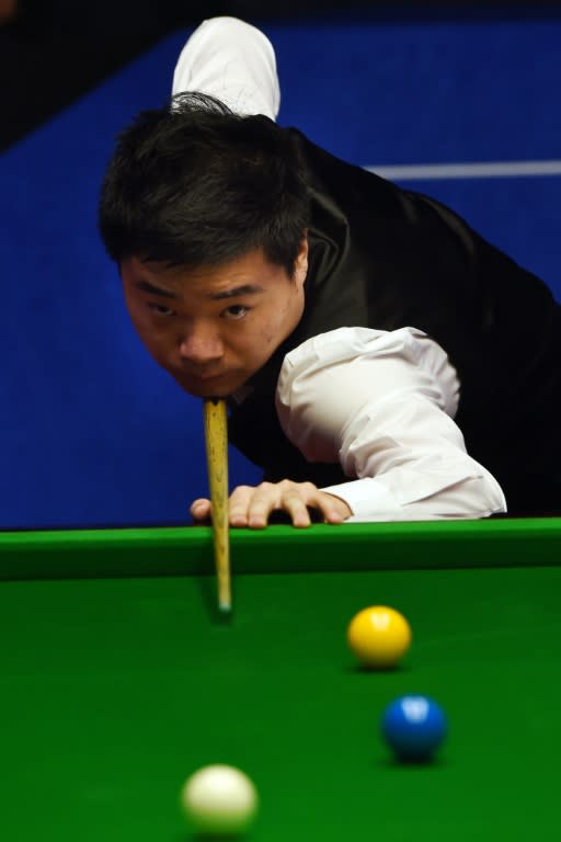 China's Ding Junhui takes part in his quarter-final match against Judd Trump of England in the World Snooker Championships at The Crucible in Sheffield, England on April 28, 2015