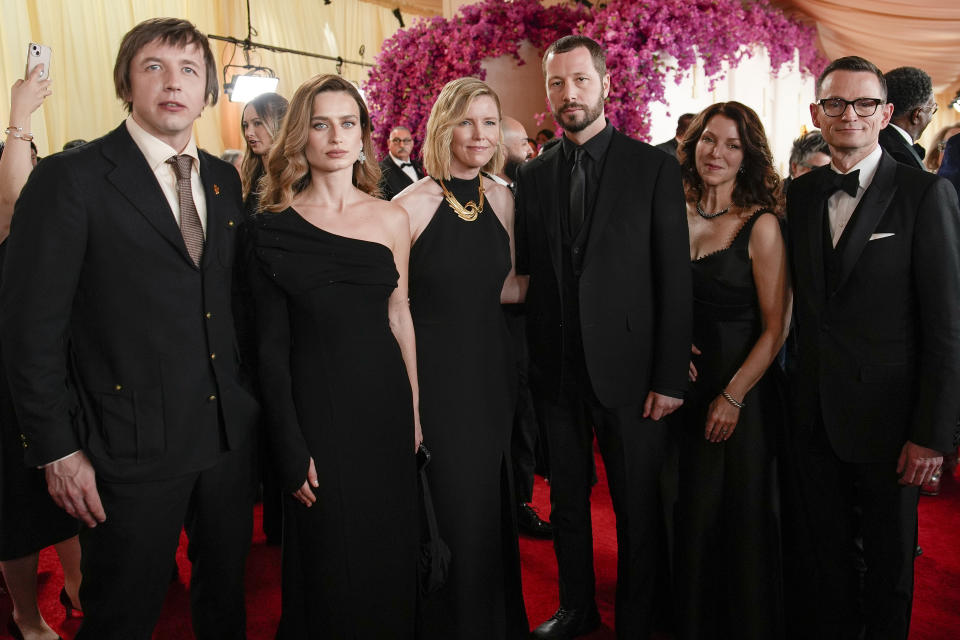 Evgeniy Maloletka, from left, Vasilisa Stepanenko, Michelle Mizner, Mstyslav Chernov, Raney Aronson-Rath and Derl McCrudden arrive at the Oscars on Sunday, March 10, 2024, at the Dolby Theatre in Los Angeles. (AP Photo/John Locher)