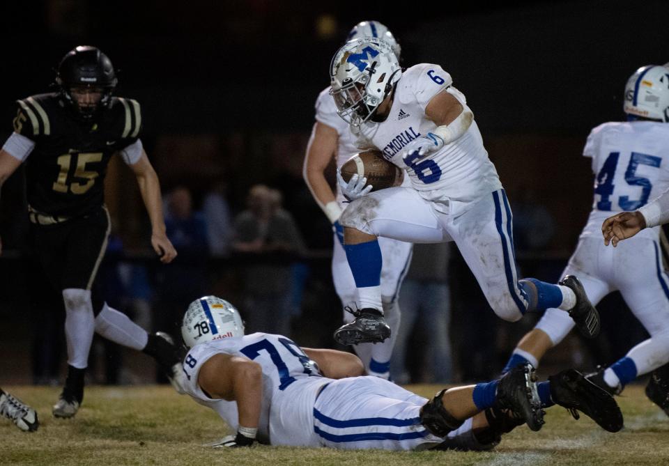 Memorial’s Porter Rode (6) hurdles through an opening on his way to a touchdown against Boonville during their IHSAA 4A Sectional Championship game at Bennett Stadium in Boonville, Ind., Friday night, Nov. 4, 2022. Memorial beat Boonville 33-14.