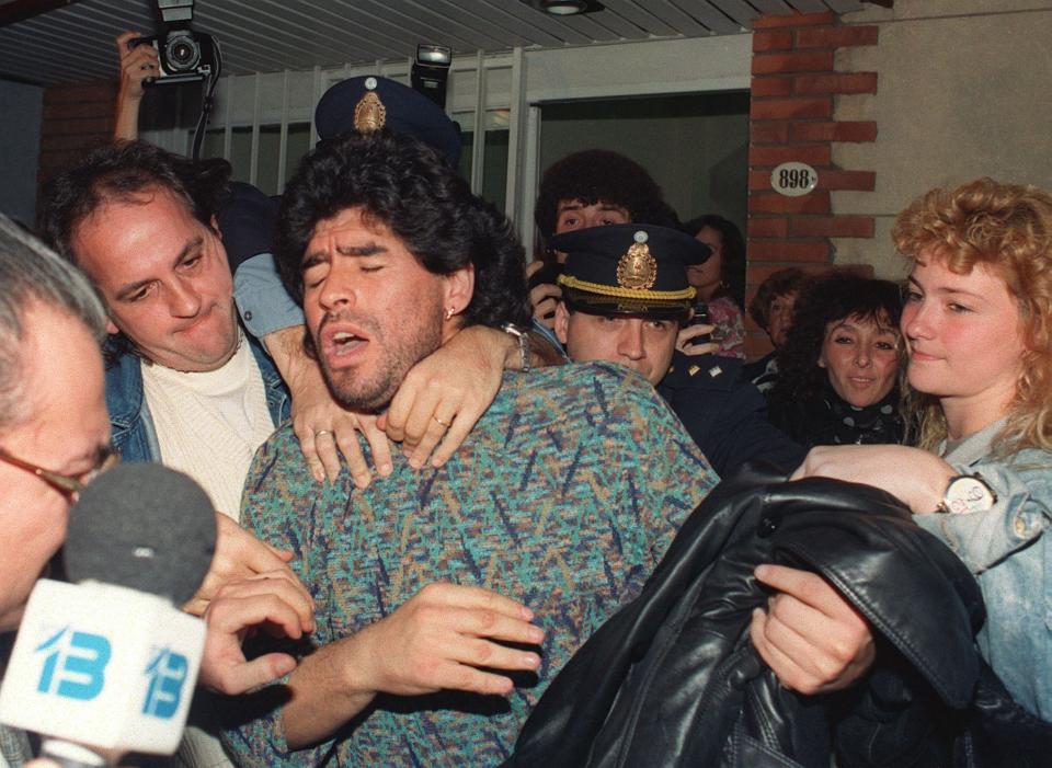 Diego Maradona is taken away by police from a Buenos Aires apartment, after being arrested for possession of half-kilo of cocaine. (PHOTO: Daniel Luna/AFP via Getty Images)