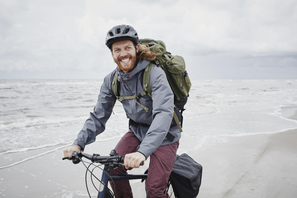 Man cycling by the sea. Source: Getty Images