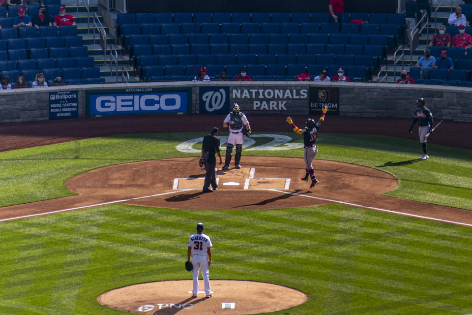 Atlanta Braves' Freddie Freeman celebrates as he comes across home plate after hitting a solo home run off of Washington Nationals starting pitcher Max Scherzer's first pitch of the game in the first inning of an opening day baseball game at Nationals Park, Tuesday, April 6, 2021, in Washington. (AP Photo/Andrew Harnik)