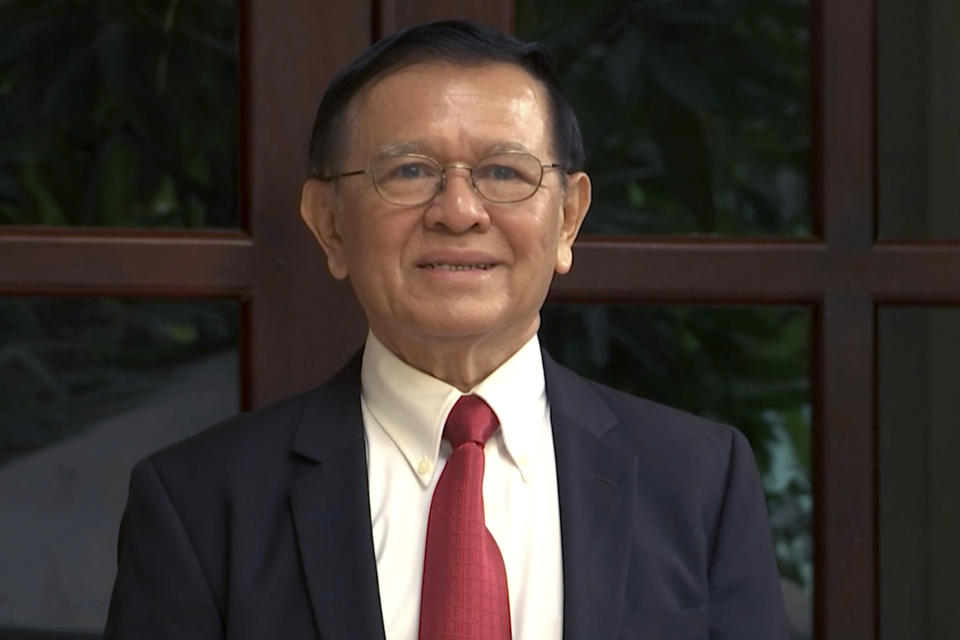 In this image made from video, Cambodia's opposition leader Kem Sokha speaks to the media on steps of his home before leaving for his trial in Phnoem Penh, Wednesday, Jan. 15, 2020. The trial of the top Cambodian opposition leader charged with treason began Wednesday, more than two years after he was arrested in what is widely seen as a politically motivated prosecution. (APTN via AP)