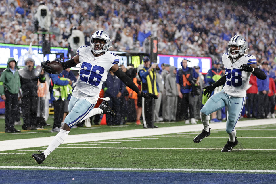 Dallas Cowboys' DaRon Bland, left, reacts as he scores after intercepting the pass intended for New York Giants' Saquon Barkley during the first half of an NFL football game, Sunday, Sept. 10, 2023, in East Rutherford, N.J. (AP Photo/Adam Hunger)