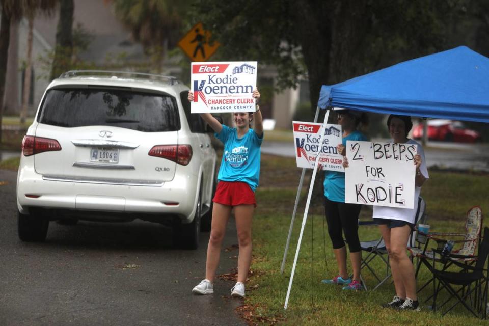 Kodie Koennen supports cheer at vehicles passing by City Hall in Diamondhead on Aug. 29, 2023. Koennen is a candidate for Hancock County chancery clerk.