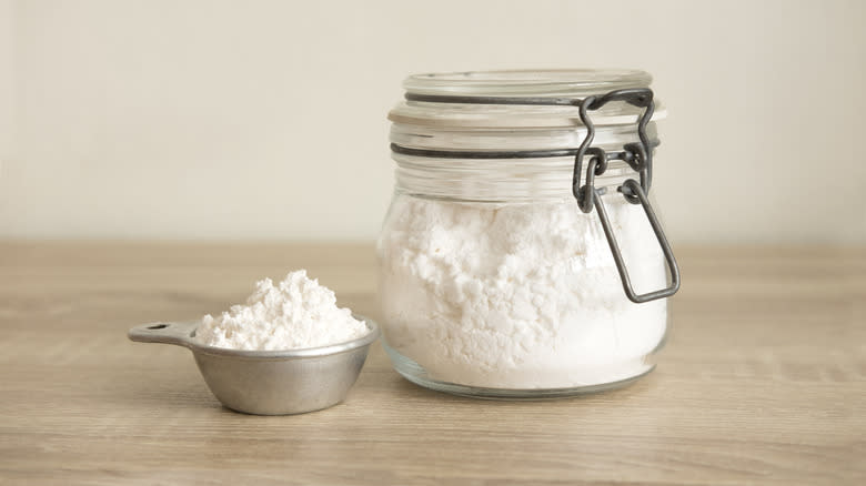 jar and measuring cup of flour
