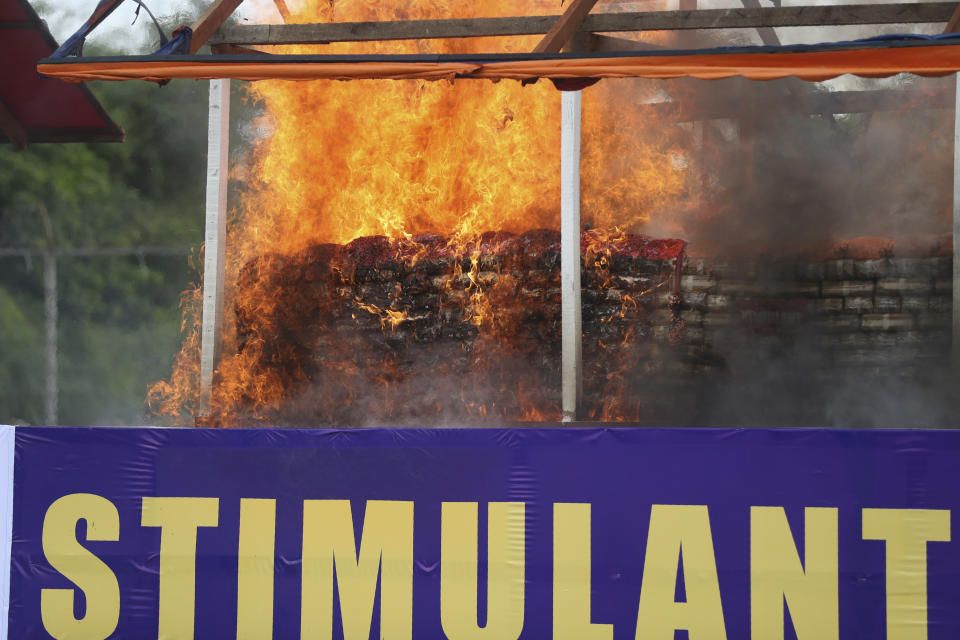 Flames and smoke rise from burning illegal drugs during a destruction ceremony to mark International Day against Drug Abuse and Illicit Trafficking outside Yangon, Myanmar, Friday, June 26, 2020. More than $839 million of seized illegal drugs were destroyed in the country on Friday, officials said. Myanmar has long been a major source of illegal drugs for East and Southeast Asia, despite repeated efforts to crack down. (AP Photo/Thein Zaw)