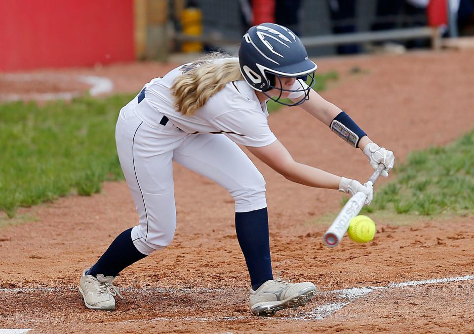 Hillsdale High School's Lacey Fickes (4) puts down a bunt in the first inning against Cuyahoga Heights High School during their OHSAA Division IV semifinal game Monday, May 16, 2022 at Akron Firestone Stadium. Hillsdale won the game 6-1. TOM E. PUSKAR/TIMES-GAZETTE.COM