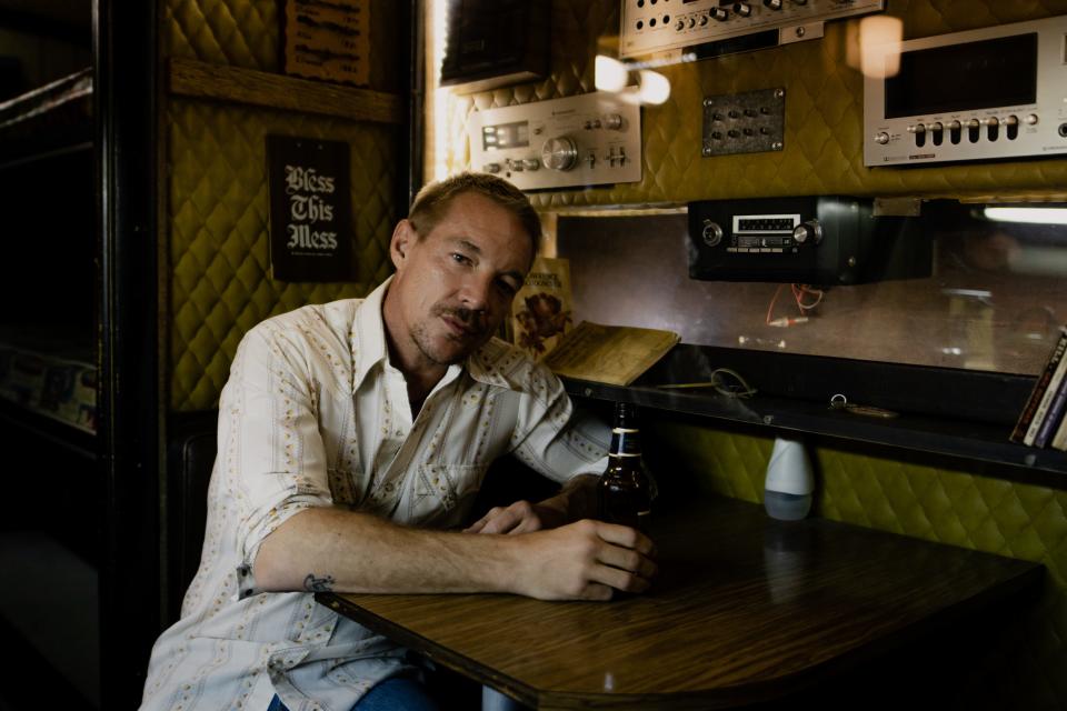 Diplo lounges in Ernest Tubb's old tour bus at Wicked Ollie's Vintage in Opryland.