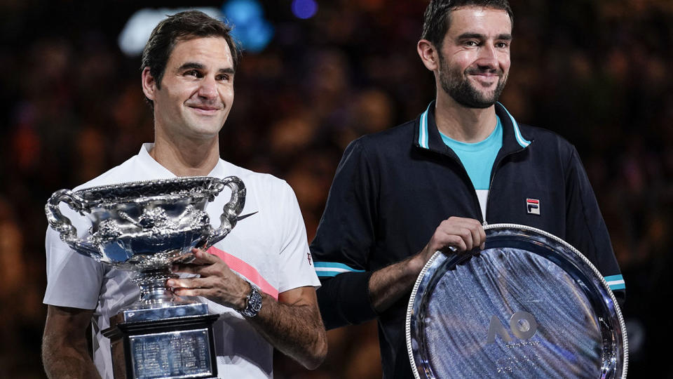 Roger Federer and Marin Cilic after the Australian Open final. (Photo by XIN LI/Getty Images)