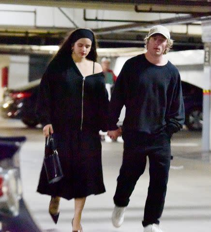 <p>TheImageDirect</p> Jeremy Allen White and Rosalía hold hands after a dinner date in Los Angeles on Dec. 1, 2023.