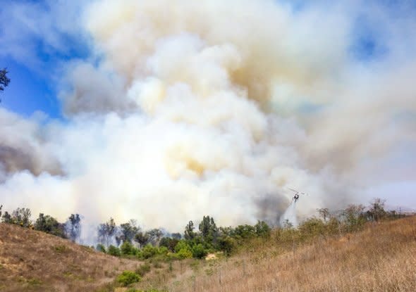 Heavy smoke was seen throughout Los Angeles on Tuesday afternoon as a brush fire threatens homes in the Beverly Crest area of Beverly Hills.