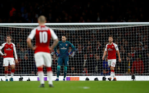 Arsenal's Nacho Monreal, David Ospina and Shkodran Mustafi look dejected after Atletico Madrid's Antoine Griezmann (not pictured) scored their first goal  - Credit: Reuters