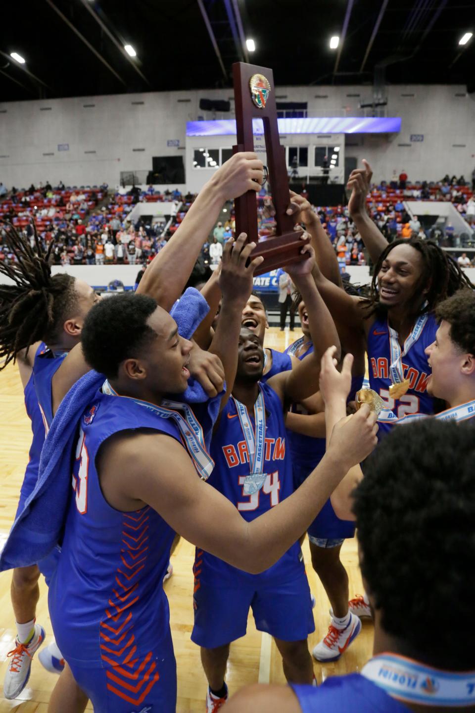 Bartow celebrates with the state championship trophy after winning its second state title in a row in March.