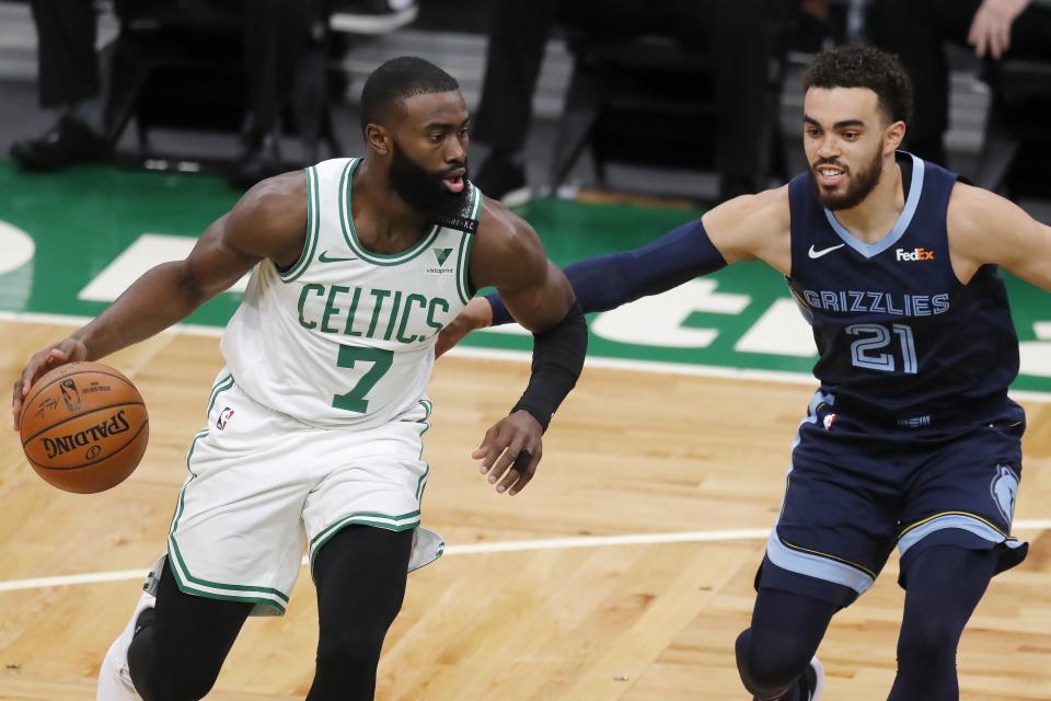 Boston Celtics' Jaylen Brown (7) drives past Memphis Grizzlies' Tyus Jones (21) during the first half of an NBA basketball game, Wednesday, Dec. 30, 2020, in Boston. (AP Photo/Michael Dwyer)