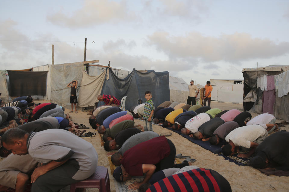 Palestinians displaced by the Israeli air and ground offensive on the Gaza Strip offer Eid al-Adha prayers at a makeshift tent camp Khan Younis, Gaza, Sunday, June 16, 2024. (AP Photo/Jehad Alshrafi)