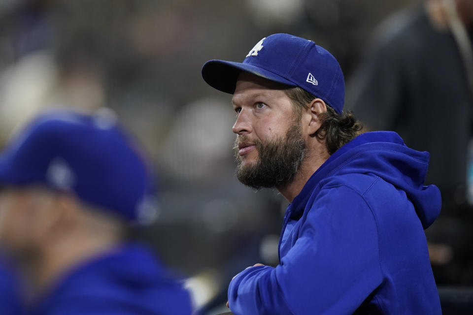 Los Angeles Dodgers starting pitcher Clayton Kershaw looks on from the dugout during the fourth inning in Game 3 of a baseball NL Division Series against the San Diego Padres, Friday, Oct. 14, 2022, in San Diego. (AP Photo/Jae C. Hong)