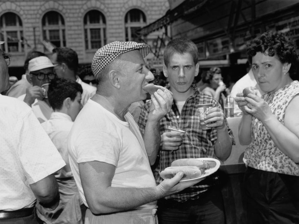 A man eats hotdogs at Nathan's Famous in Coney Island on July 4, 1961