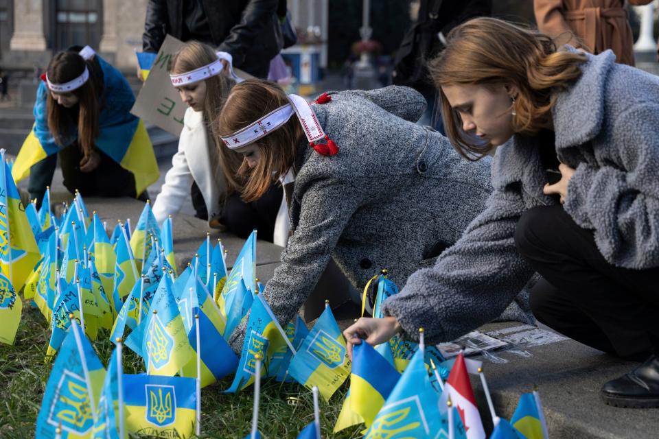 Ukrainian students, who lost relatives due to the Russia-Ukrainian war set flags in their memory (Copyright 2023 The Associated Press. All rights reserved.)