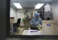 A Nepalese hospital staff works at a laboratory at the Tilganga Eye Center in Kathmandu, Nepal, March 26, 2021. Nepal’s “God of Sight” eye doctor renowned for his innovative and inexpensive cataract surgery for the poor is taking his work beyond the Himalayan mountains to other parts of the world so there is no more unnecessary blindness in the world. Dr. Sanduk Ruit, who has won many awards for his work and performed some 130,000 cataract surgery in the past three decades, is aiming to expand his work beyond the borders of his home country and the region to go globally. (AP Photo/Niranjan Shrestha)