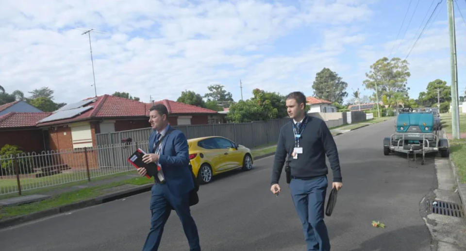 Investigators walking in the neighbourhood where the baby was found.