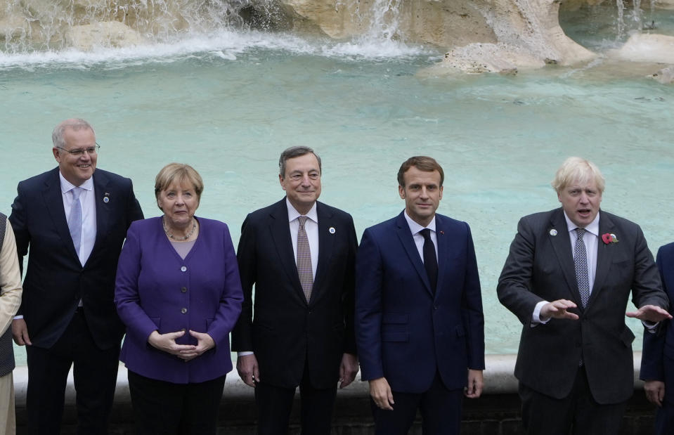 From left, Australia's Prime Minister Scott Morrison, German Chancellor Angela Merkel, Italy's Prime Minister Mario Draghi, French President Emmanuel Macron and British Prime Minister Boris Johnson pose in front of the Trevi Fountain during an event for the G20 summit in Rome, Sunday, Oct. 31, 2021. The two-day Group of 20 summit concludes on Sunday, the first in-person gathering of leaders of the world's biggest economies since the COVID-19 pandemic started. (AP Photo/Gregorio Borgia)