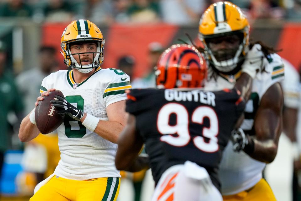 Green Bay Packers quarterback Sean Clifford (8) drops back to throw in the second quarter of the NFL Preseason Week 1 game between the Cincinnati Bengals and the Green Bay Packers at Paycor Stadium in downtown Cincinnati on Friday, Aug. 11, 2023. The Packers led 21-16 at halftime.