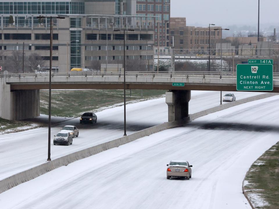 Very light traffic travels along downtown Little Rock, Ark., after sleet and snow fell early Monday, Feb. 16, 2015.