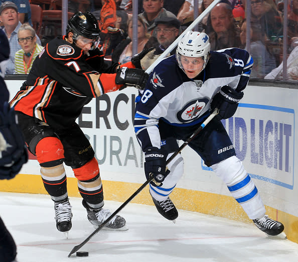 ANAHEIM, CA - APRIL 5: Jacob Trouba #8 of the Winnipeg Jets skates with the puck against Andrew Cogliano #7 of the Anaheim Ducks on April 5, 2016 at Honda Center in Anaheim, California. (Photo by Debora Robinson/NHLI via Getty Images)