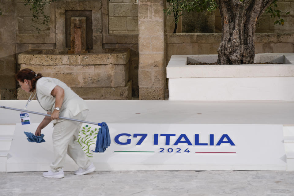 A worker cleans the stage of the G7 summit, Thursday, June 13, 2024, in Borgo Egnazia, Italy. (AP Photo/Alex Brandon)