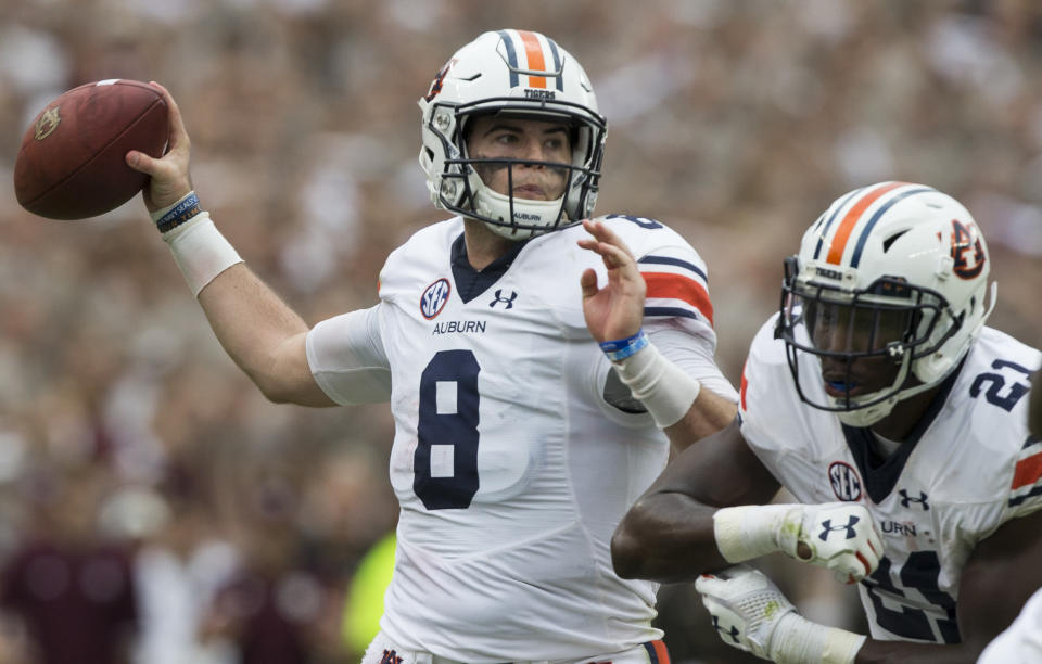 Auburn quarterback Jarrett Stidham (8) passes down field against Texas A&M during the first half of an NCAA college football game on Saturday, Nov. 4, 2017, in College Station, Texas. (AP Photo/Sam Craft)