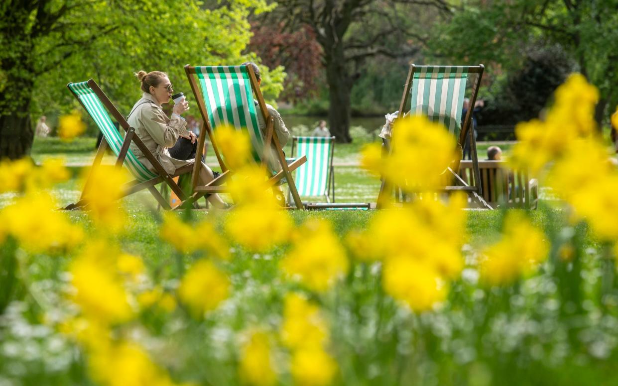 Not a complete washout: visitors to St James's Park in central London sunning themselves in the middle of April, 2024