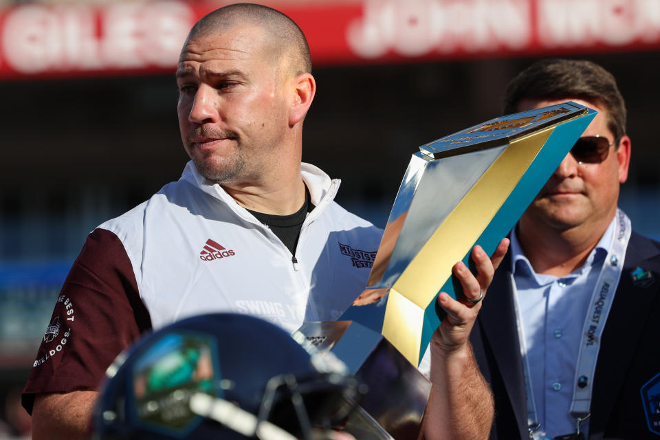 Jan 2, 2023; Tampa, FL, USA; Mississippi State Bulldogs head coach Zach Arnett is presented the trophy after beating the <a class="link " href="https://sports.yahoo.com/ncaaw/teams/illinois/" data-i13n="sec:content-canvas;subsec:anchor_text;elm:context_link" data-ylk="slk:Illinois Fighting Illini;sec:content-canvas;subsec:anchor_text;elm:context_link;itc:0">Illinois Fighting Illini</a> in the 2023 ReliaQuest Bowl at Raymond James Stadium. Mandatory Credit: Nathan Ray Seebeck-USA TODAY Sports