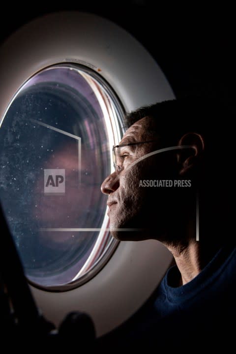 In this photo provided by NASA, astronaut Frank Rubio peers out of a window aboard the SpaceX Dragon Freedom spacecraft docked to the International Space Station. Rubio was observing the SpaceX Dragon Endurance spacecraft, carrying four SpaceX Crew-5 crew members, approach the orbital lab for a docking to the Harmony module’s forward port. Rubio and Russian cosmonauts Sergey Prokopyev and Dmitri Petelin are expected to return to Earth on Wednesday, Sept; 27, 2023, after being stuck in space for just over a year after their original capsule was hit by space junk. The 180-day mission turned into a 371-day stay. (NASA via AP)