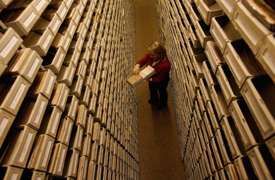 An employee of the ITS (International Tracing Service) researches documents at the Holocaust Archive on April 28, 2006 in Bad Arolsen, Germany.  (Photo by Ralph Orlowski/Getty Images)