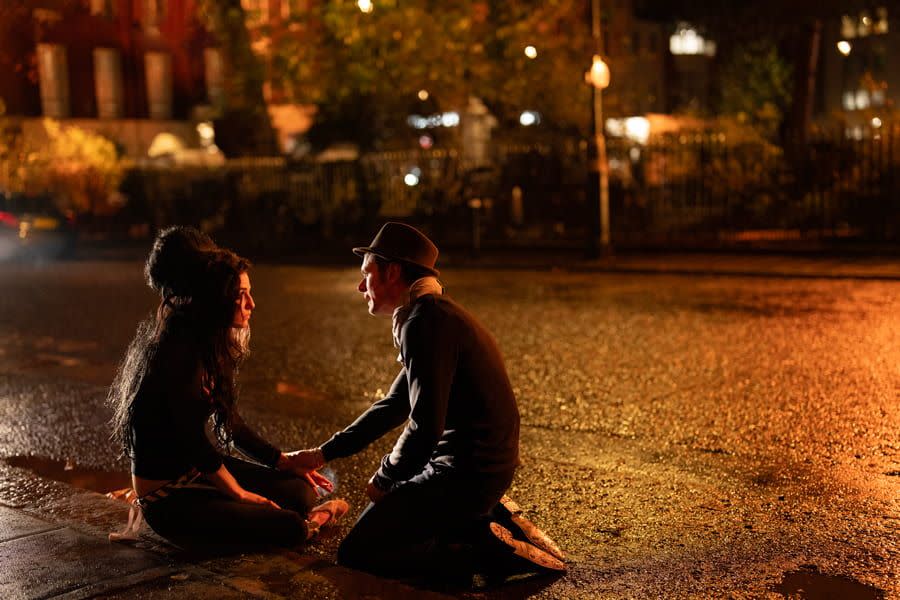 a man and woman sitting in the rain