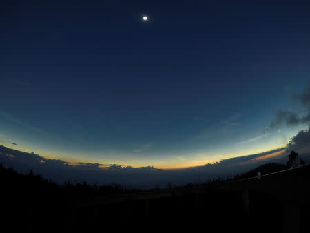 Clouds clear away in the minutes just before the solar eclipse reached totality seen from the observation tower atop Clingmans Dome, which at 6,643 feet (2,025m) is the highest point in the Great Smoky Mountains National Park, Tennessee, U.S. August 21, 2017. Location coordinates for this image are 35°33'24" N, 83°29'46" W. REUTERS/Jonathan Ernst