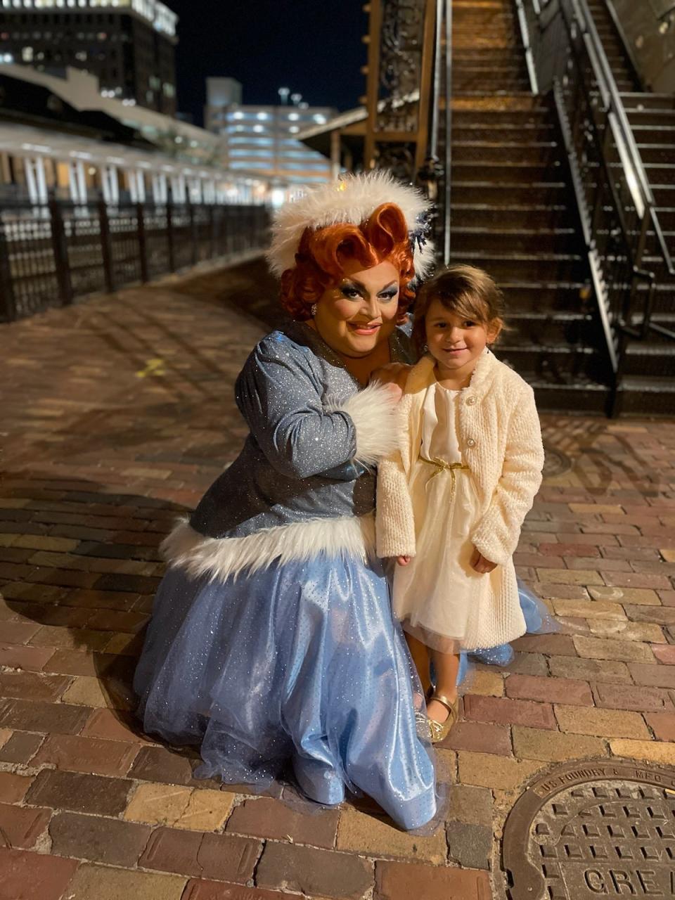 Orlando-based drag queen Ginger Minj poses for a picture with Olivia, the 7-year-old granddaughter of Mary Taylor Green, a DeLand resident who said her granddaughter has been hurt by the state's decision to block children from being able to see drag performances.