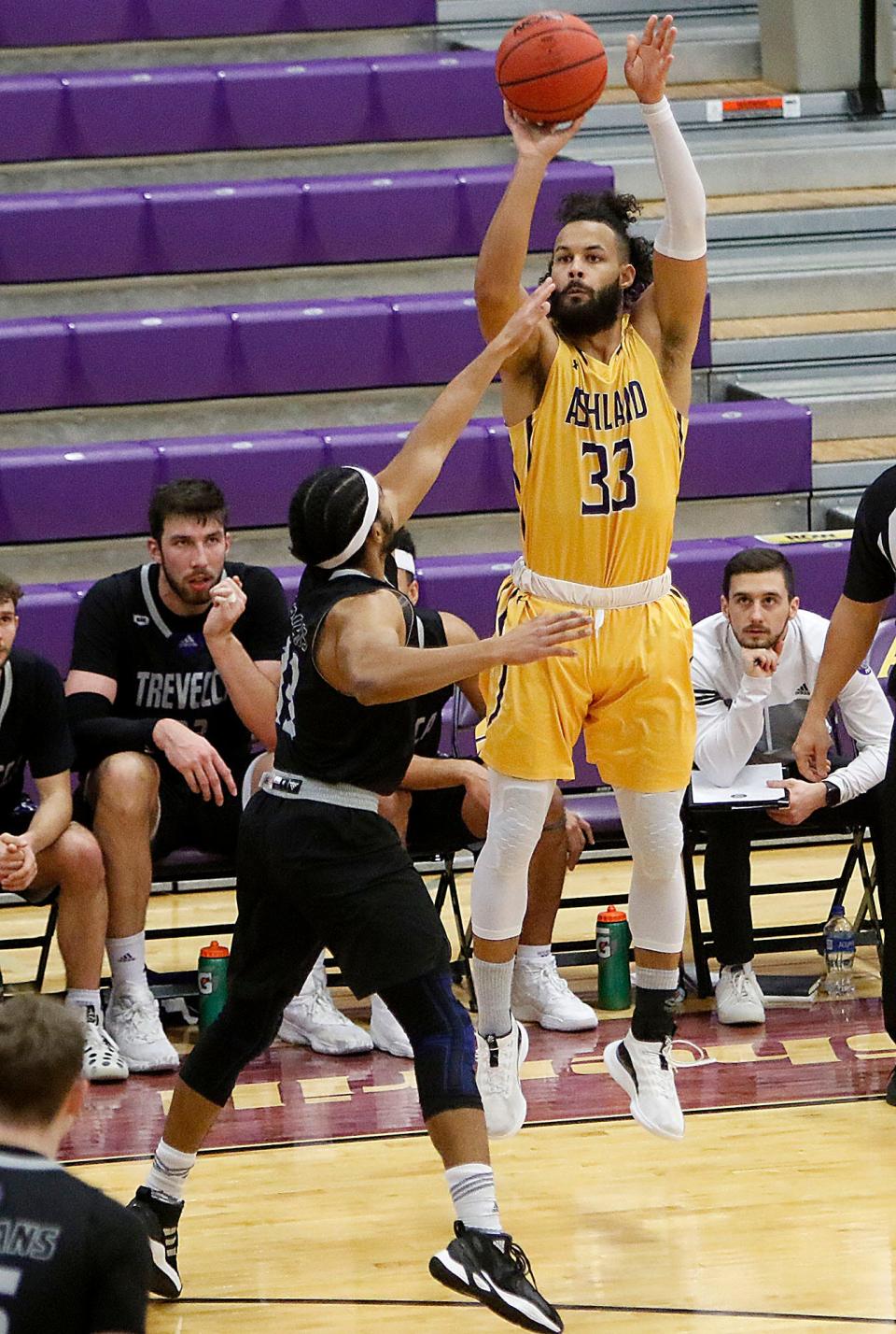 Ashland University's Ethan Conley (33) shoots as Trevecca Nazarene University's Jaylon Tharpe (13) defends during college men's basketball action Monday, Jan. 24, 2022 at Kates Gym. TOM E. PUSKAR/TIMES-GAZETTE.COM