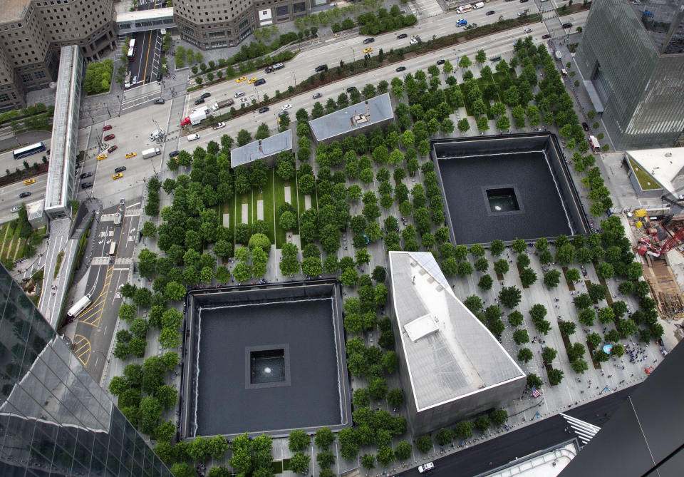 FILE - In this June 7, 2018 file photo, the World Trade Center site is seen from an upper floor of 3 World Trade Center in New York. The annual 9/11 commemorations are by now familiar rituals, centered on reading the names of the dead. But each year at ground zero, victims' relatives infuse the ceremony with personal messages of remembrance, concern and inspiration. And there building continues. A subway station destroyed on 9/11 finally reopened, as did the doors at the 80-story 3 World Trade Center, one of several rebuilt office towers that have been constructed or planned at the site. (AP Photo/Mark Lennihan, FIle)