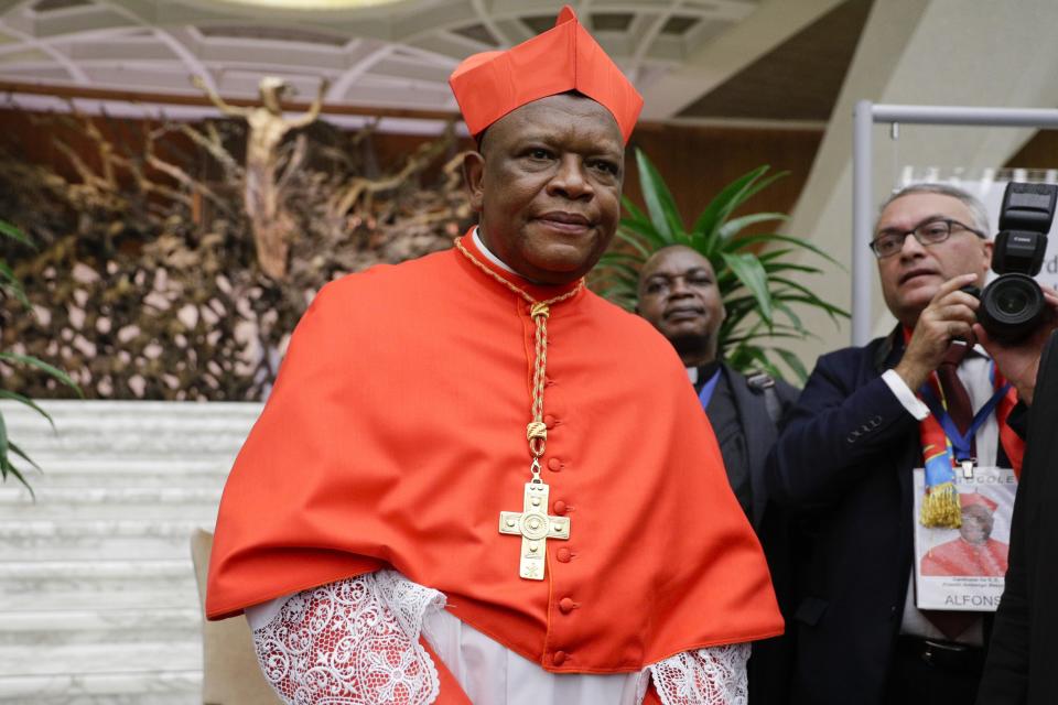 Cardinal Fridolin Among Besungu poses for photographers prior to meeting relatives and friends after he was elevated to cardinal by Pope Francis, at the Vatican, Saturday, Oct. 5, 2019. Pope Francis has chosen 13 men he admires and whose sympathies align with his to become the Catholic Church's newest cardinals. (AP Photo/Andrew Medichini)