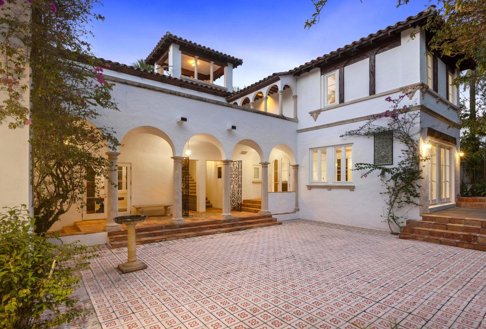 The layout of the landmarked house at 137 El Vedado Road pivots around the tiled entrance courtyard, which has an arched loggia opposite the main entrance gate. Doorways in the loggia lead to the foyer and stair hall. The house is listed for sale at $29 million.