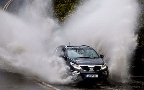 car floodwater spray - Credit: Owen Humphreys/PA