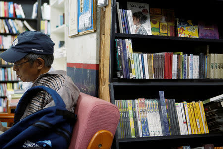 Former Causeway Bay Books employee Lam Wing-kee reads at a bookshop in Taipei, Taiwan April 29, 2019. REUTERS/James Pomfret