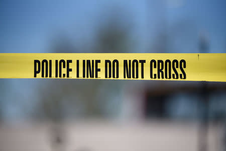 Crime scene tape blocks off an area designated for the media at the scene of a blast at a FedEx facility in Schertz, Texas, U.S., March 20, 2018. REUTERS/Sergio Flores