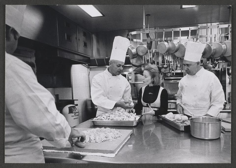 In this photograph, taken November 18, 1969, White House Executive Chef Henry Haller discusses meal preparation with Social Secretary Lucy Winchester, while Pastry Chef Heinz Bender (right) looks on.