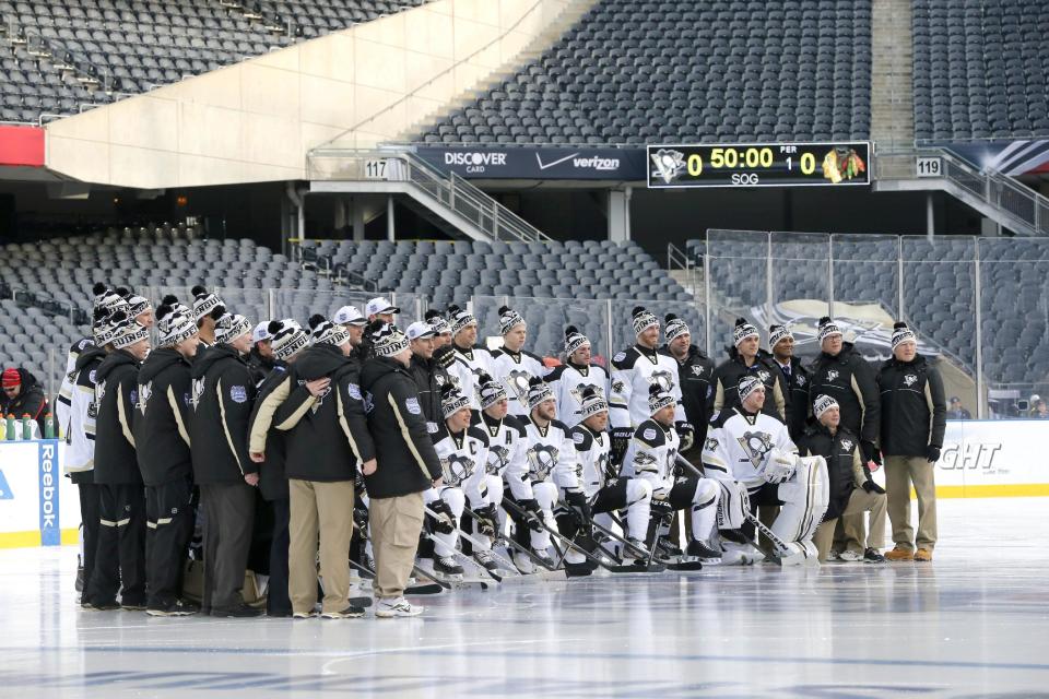 The Pittsburgh Penguins pose for a team photo on the Soldier Field ice, site of Saturday's Stadium Series NHL hockey game between the Penguins and the Chicago Blackhawks, Friday, Feb. 28, 2014, in Chicago. (AP Photo/Charles Rex Arbogast)