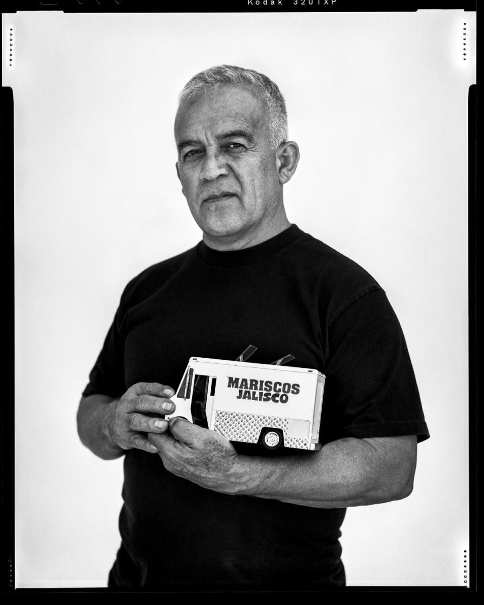 Los Angeles, CA - June 09: Raul Ortega holds a miniature food truck patterned after his real-life Mariscos Jalisco, truck.